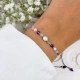 zodiakalna bransoletka ryby z perłą i kamieni na dłoni